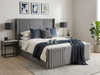 The Pepita Ottoman Storage Bed upholstered in plush grey velvet, featuring a tall, vertical fluted winged headboard. Handcrafted luxury bed by Hush My Bed